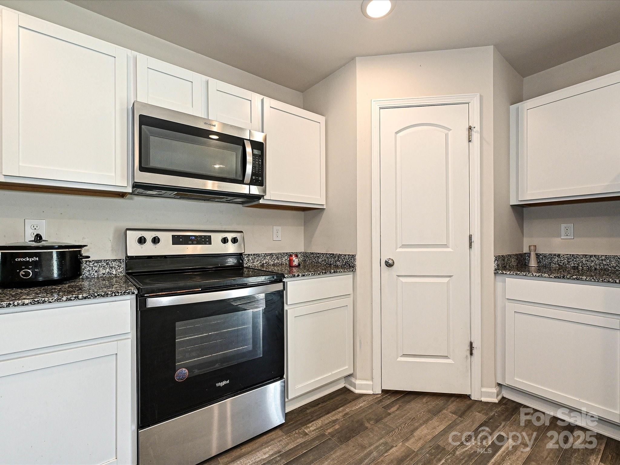 323-j C J C Dellinger Road Cherryville, NC 28021 - Photo 2 of 29 a kitchen with stainless steel appliances granite countertop a stove a microwave and a white cabinets