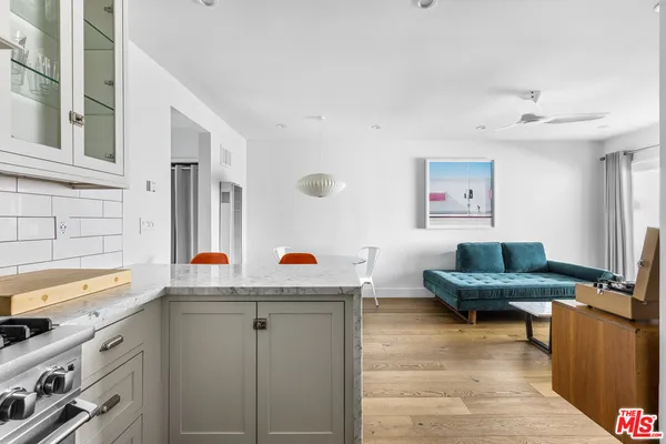 a white stove top oven sitting inside of a kitchen