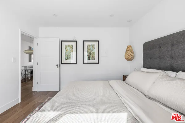 a bedroom with a bed and a lamp