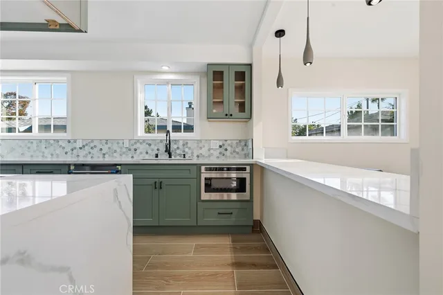 a kitchen with stainless steel appliances granite countertop a stove and cabinets