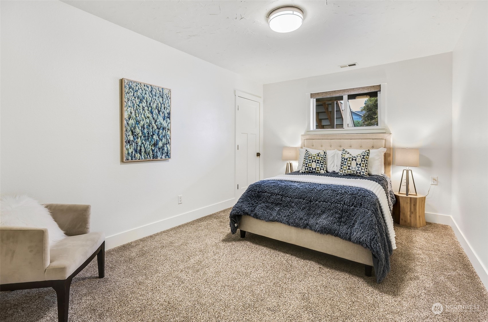 4114 Northeast 22nd Place Renton, WA 98059 - Photo 19 of 28 a spacious bedroom with a bed and a chair