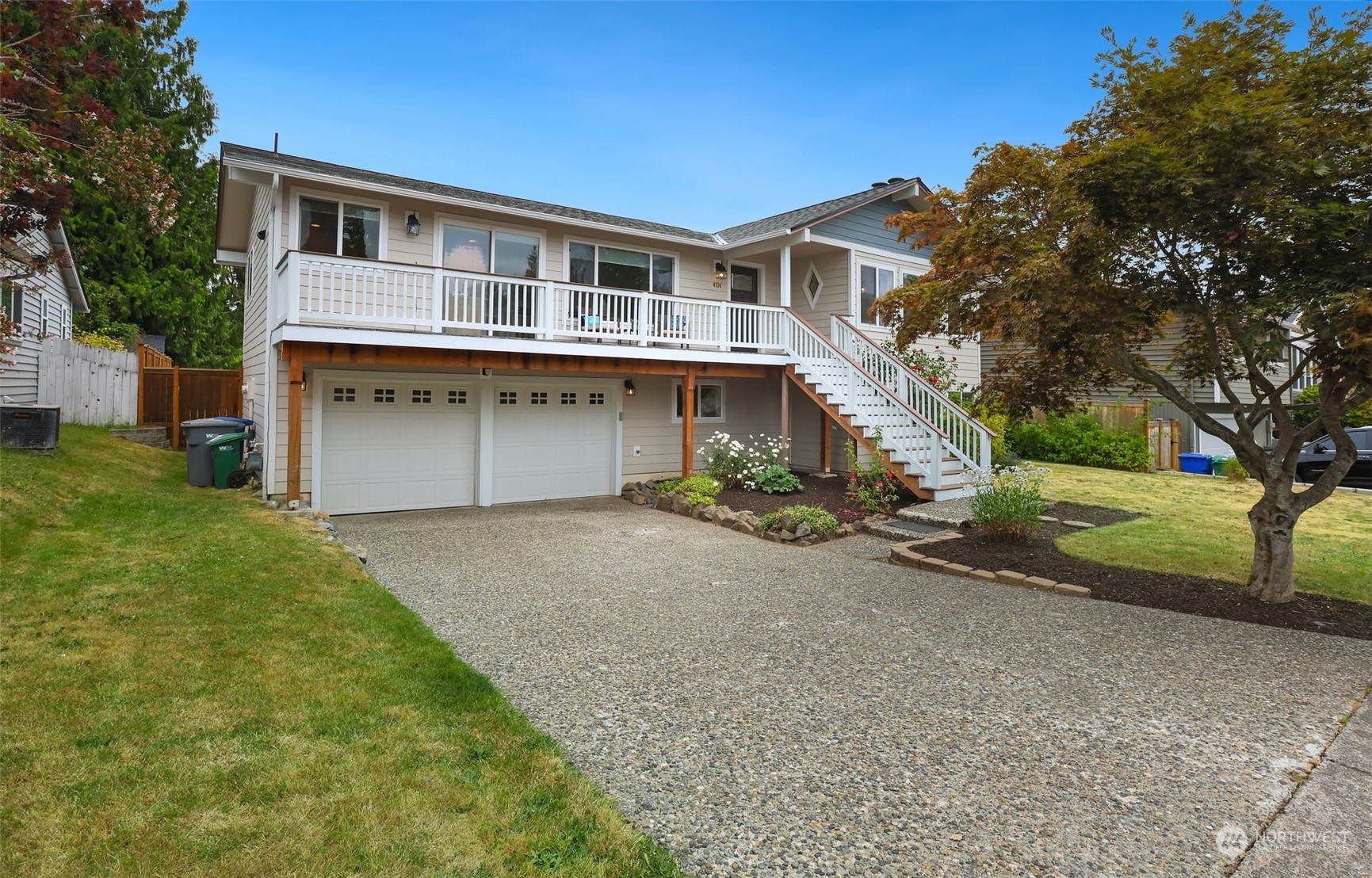 4114 Northeast 22nd Place Renton, WA 98059 - Photo 2 of 28 a front view of a house with a yard and garage