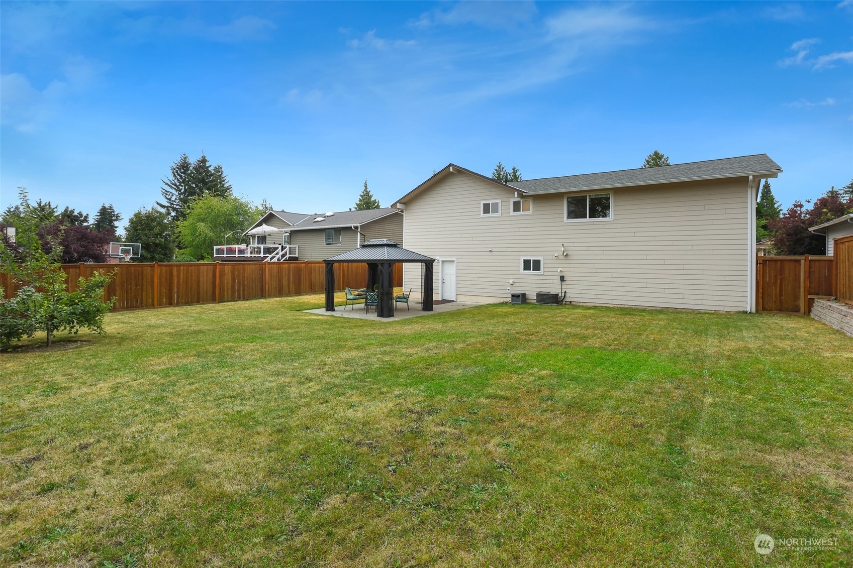 4114 Northeast 22nd Place Renton, WA 98059 - Photo 22 of 28 a front view of house with yard and trees in the background