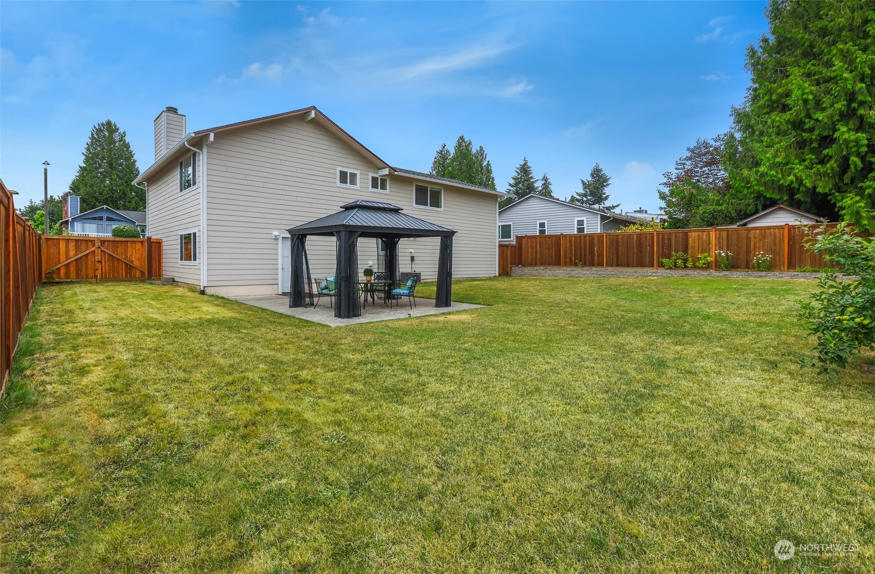 4114 Northeast 22nd Place Renton, WA 98059 - Photo 23 of 28 a view of a house with a yard and trees