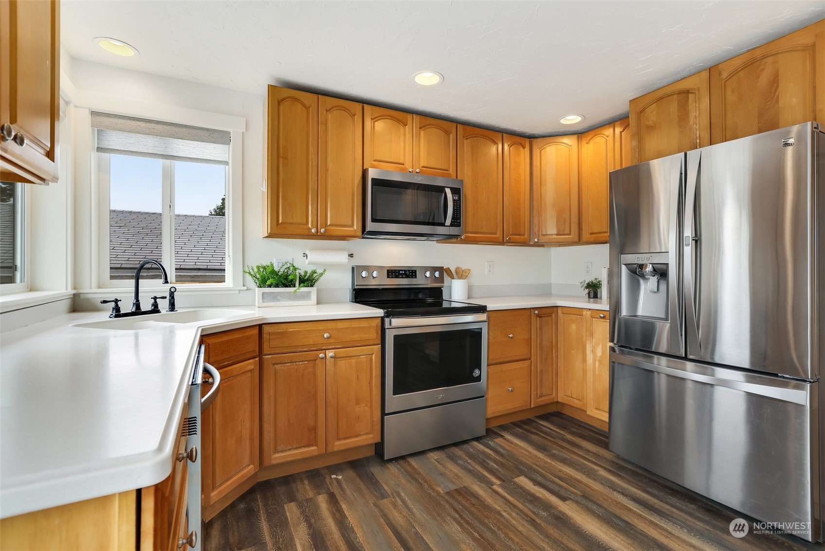 4114 Northeast 22nd Place Renton, WA 98059 - Photo 5 of 28 a kitchen with granite countertop a refrigerator a stove top oven a sink and cabinets