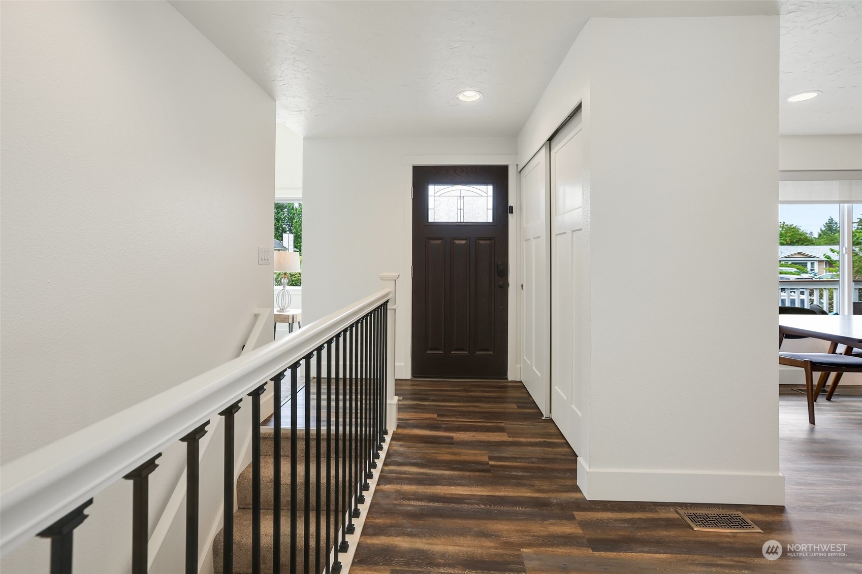4114 Northeast 22nd Place Renton, WA 98059 - Photo 7 of 28 a view of a hallway with wooden floor and a living room