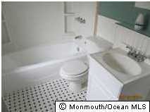 122 Breton Road Brick, NJ 08723 - Photo 3 of 12 a bathroom with a sink a toilet and a bathtub