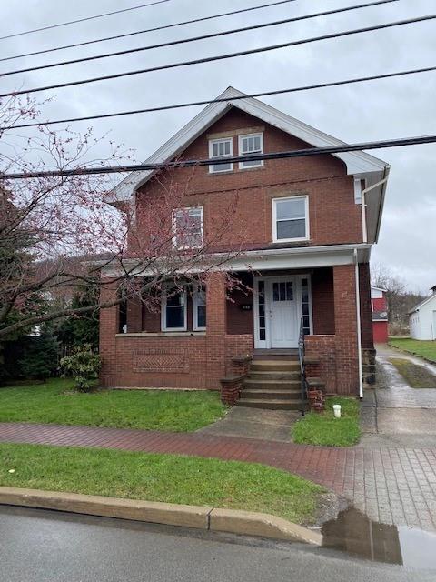 a front view of a house with a yard