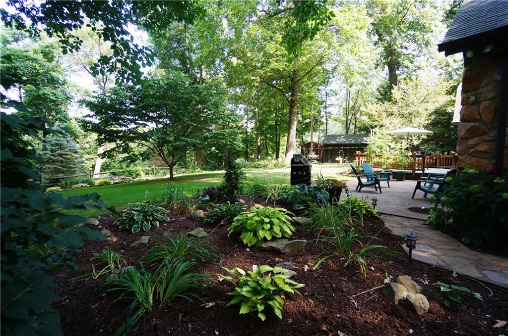 45 Dovercrest Road Eighty Four, PA 15330 - Photo 2 of 25 Enjoy the shade under the trees on the stone patio or the Sunny deck...Check out the double shed can hold a CH5 Jeep