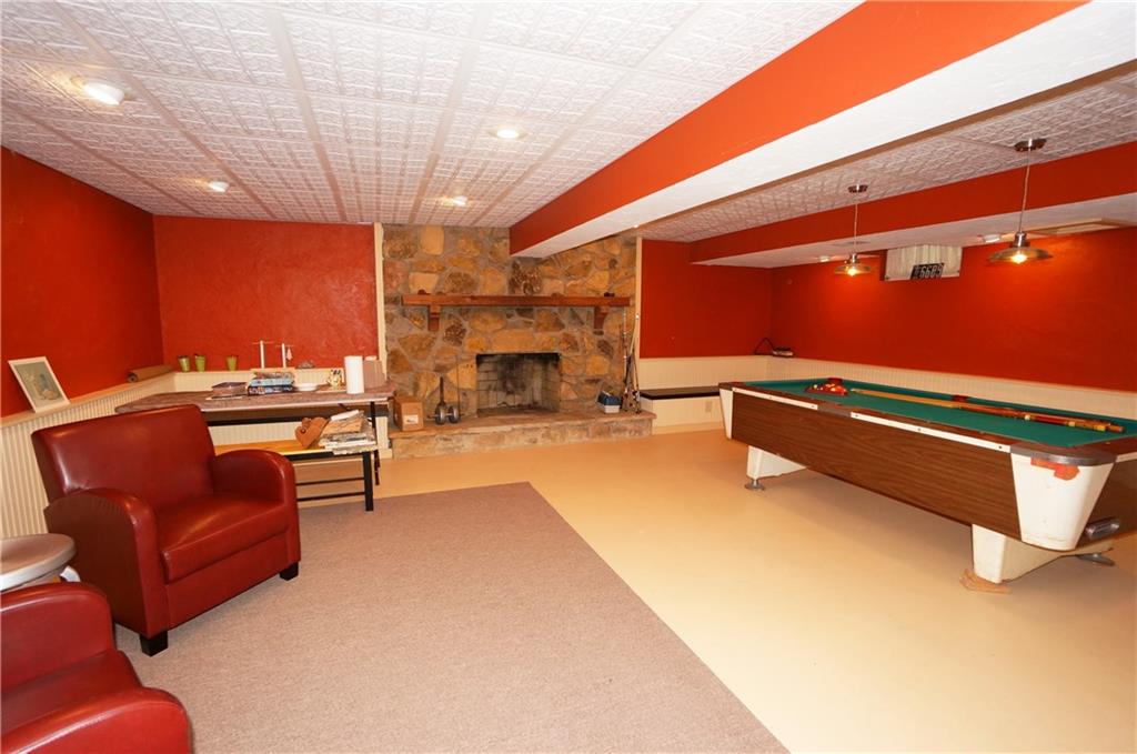 45 Dovercrest Road Eighty Four, PA 15330 - Photo 22 of 25 Partial view of lower level game room w stone FP w flanking benches double as storage. Pool table included