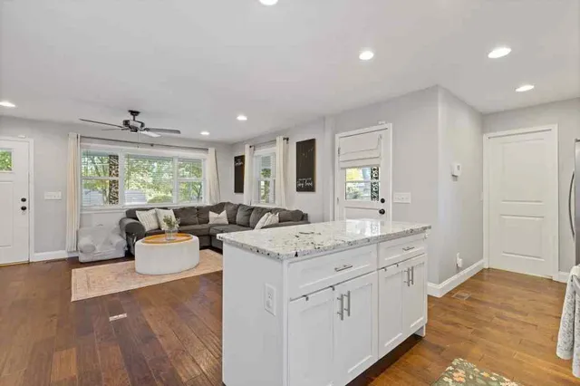 a living room with kitchen island furniture and a large window
