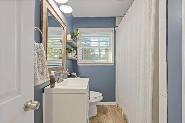 a bathroom with a sink toilet and mirror