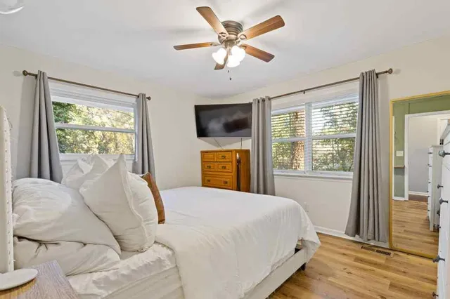 a bedroom with a bed and a flat screen tv