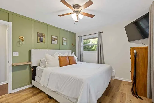 a bedroom with a bed and a flat screen tv