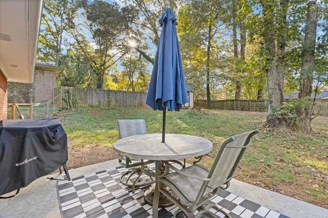 a view of a backyard with furniture