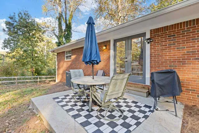 a view of a patio with a dining table and chairs