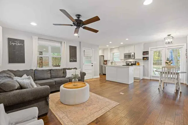 a living room with furniture and a wooden floor
