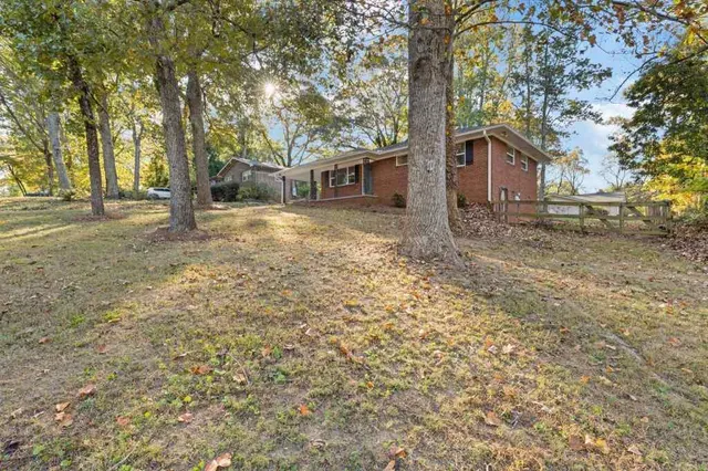 a tree in front of a white house