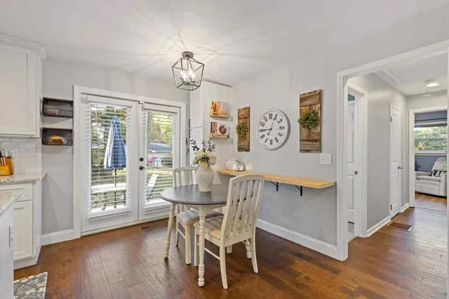 a view of a dining room with furniture large window and wooden floor