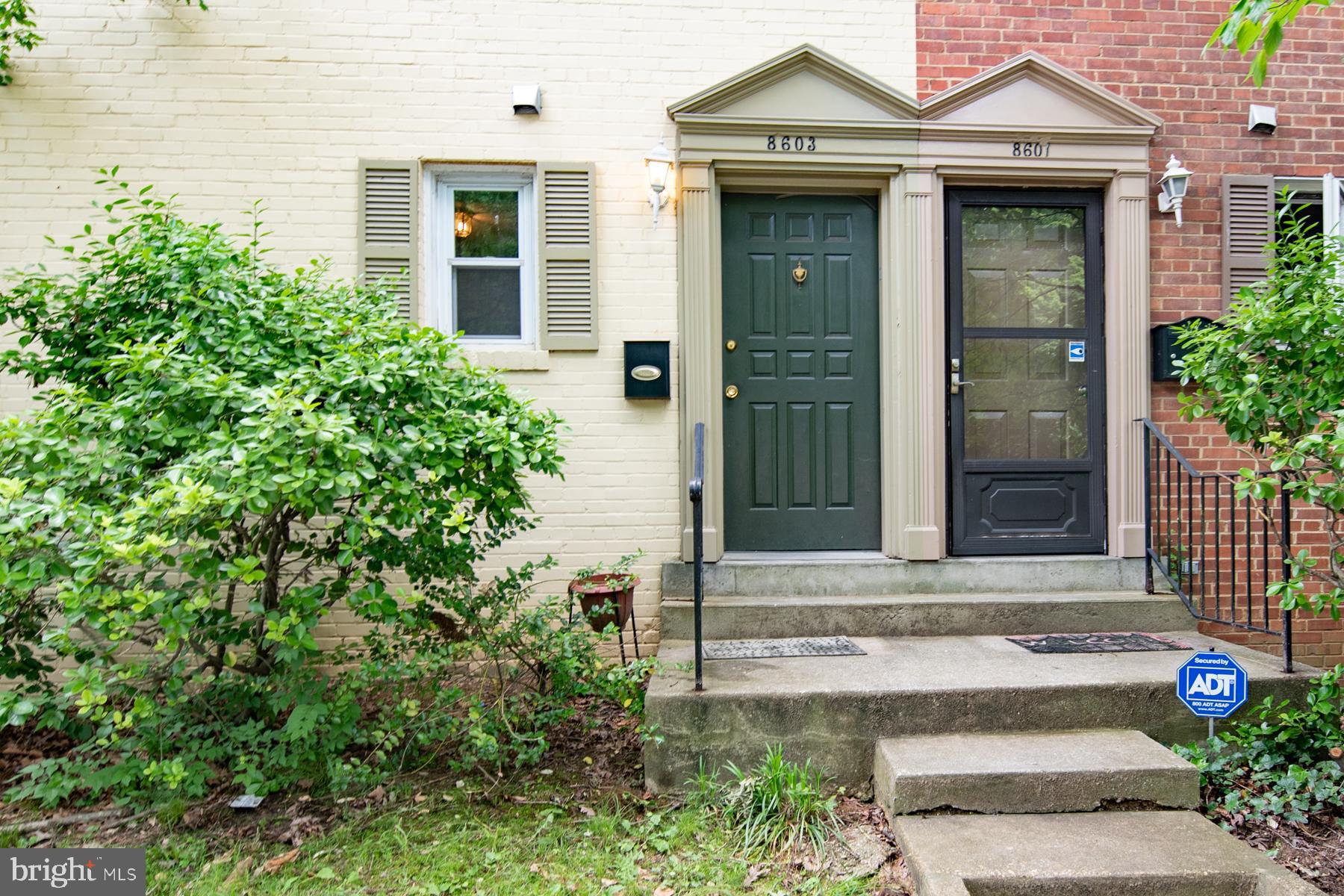 8603 Bradford Road, Unit 105 Silver Spring, MD 20901 - Photo 4 of 36 front view of a house with potted plants