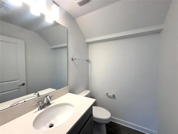 a bathroom with a sink toilet and vanity