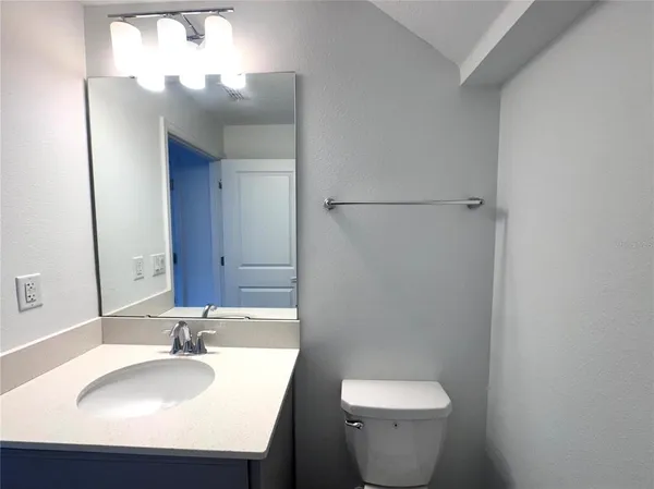 a bathroom with a sink toilet and a mirror