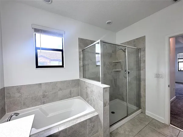 a bathroom with a bathtub and shower