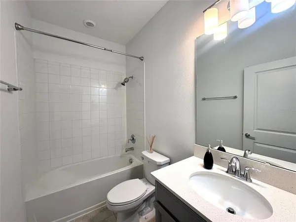 a bathroom with a sink toilet tub and shower