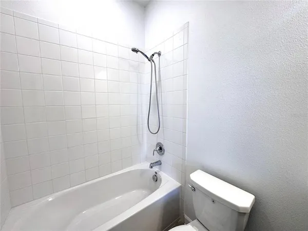 a bathroom with a toilet and shower