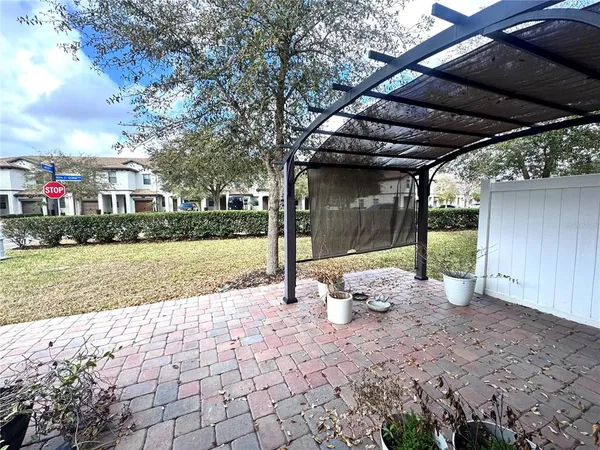 a view of a white house with a yard