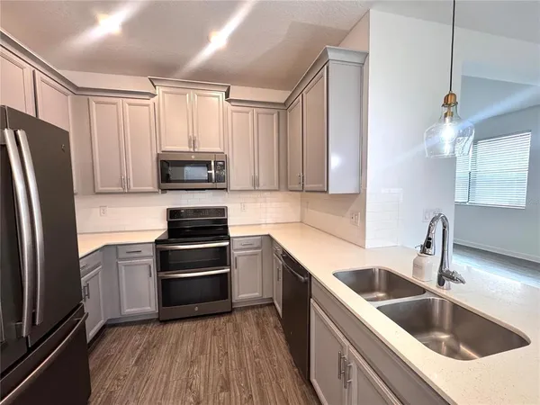 a kitchen with a sink stove and refrigerator
