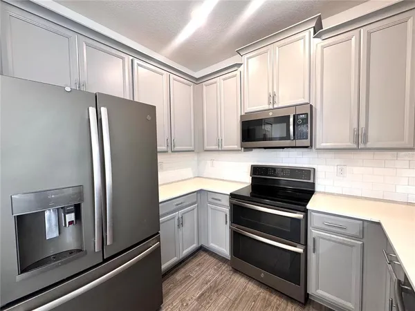 a kitchen with stainless steel appliances and cabinets