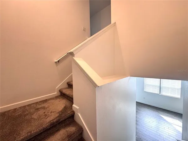 a view of room with window and wooden floor