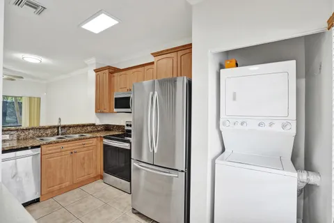 a kitchen with a refrigerator sink and cabinets