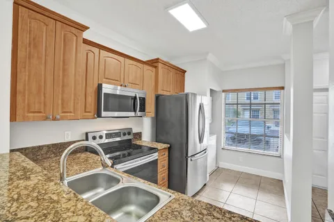 a kitchen with a refrigerator sink and stove