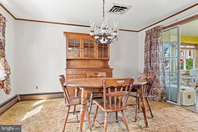 a view of a dining room with furniture and chandelier