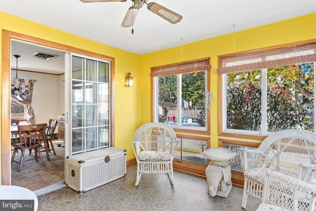 a living room with furniture and large windows