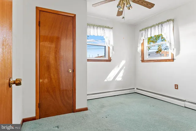 an empty room with windows and closet