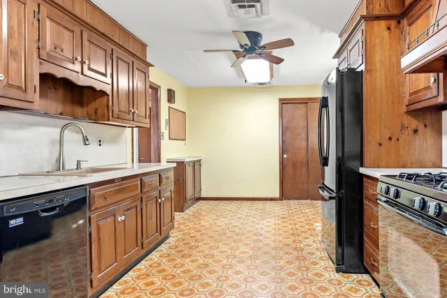 a kitchen with stainless steel appliances granite countertop a sink and cabinets