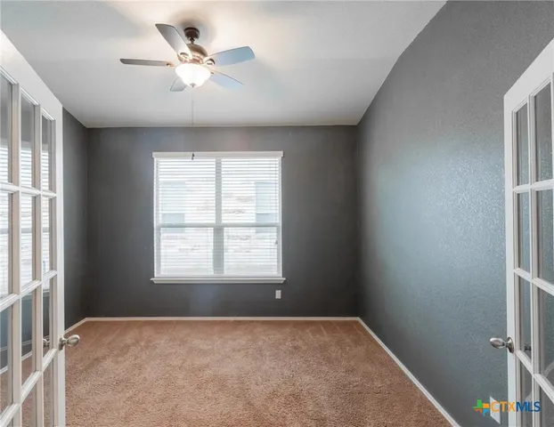 a view of an empty room with a window