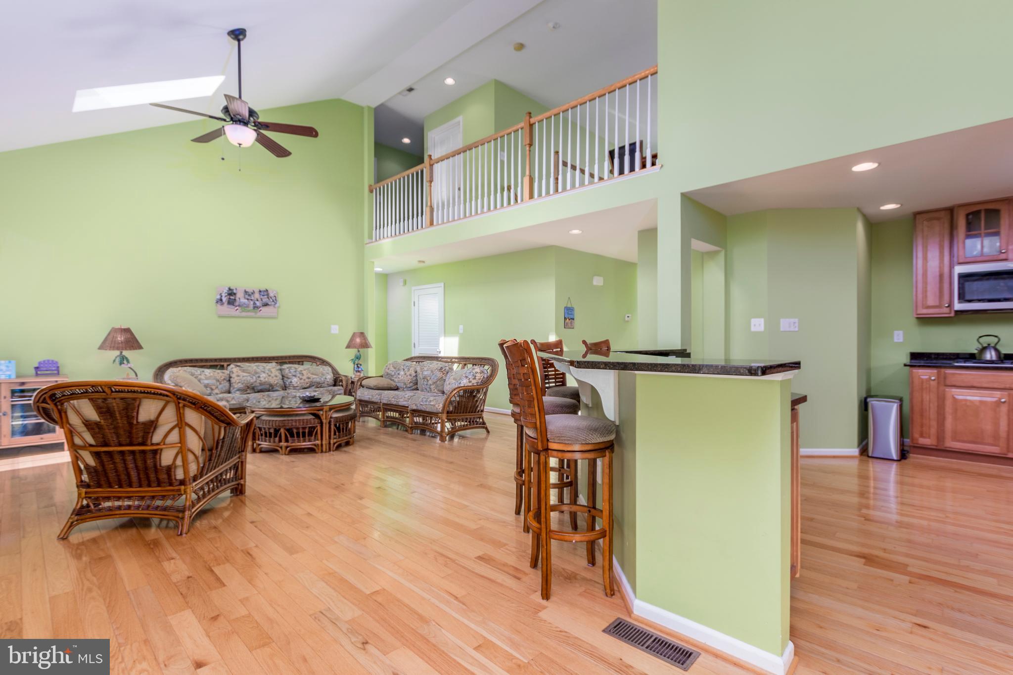 31762 Skimmer Road Ocean View, DE 19970 - Photo 21 of 52 Great Room and Kitchen/ Hardwood Floors