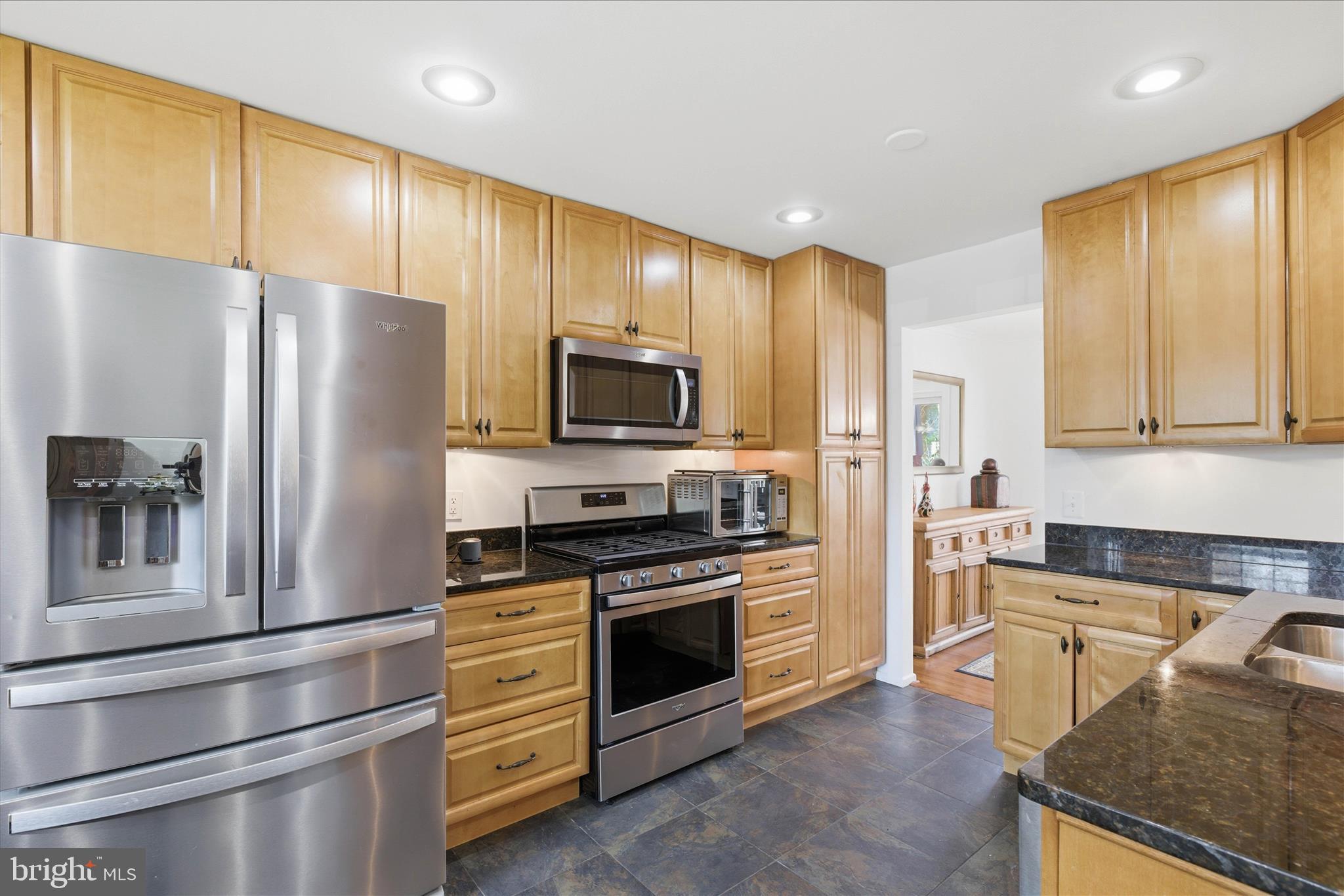 2510 Swift Run Street Vienna, VA 22180 - Photo 11 of 42 a kitchen with stainless steel appliances granite countertop a refrigerator stove and microwave