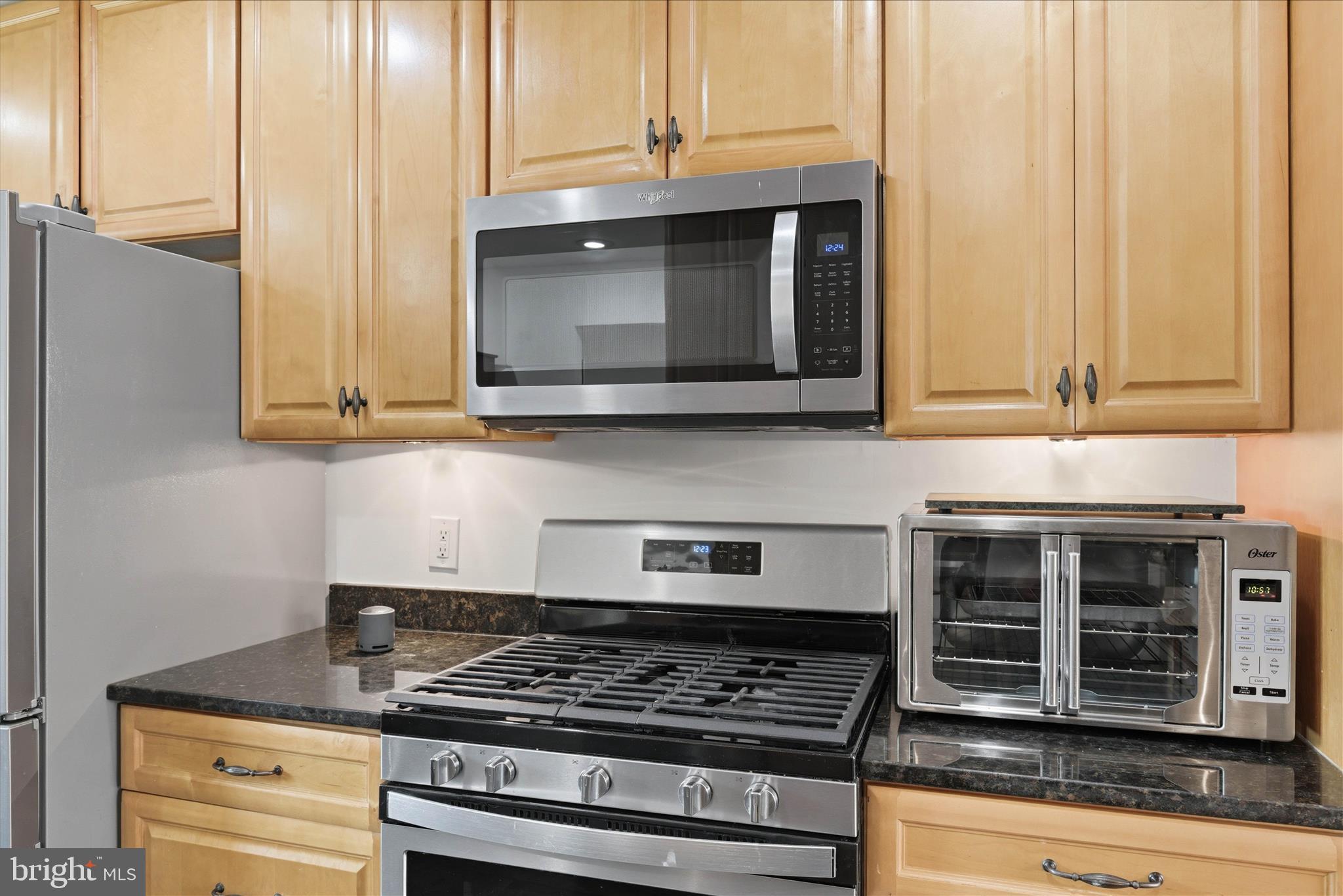 2510 Swift Run Street Vienna, VA 22180 - Photo 13 of 42 a kitchen with granite countertop white cabinets stainless steel appliances and a counter space