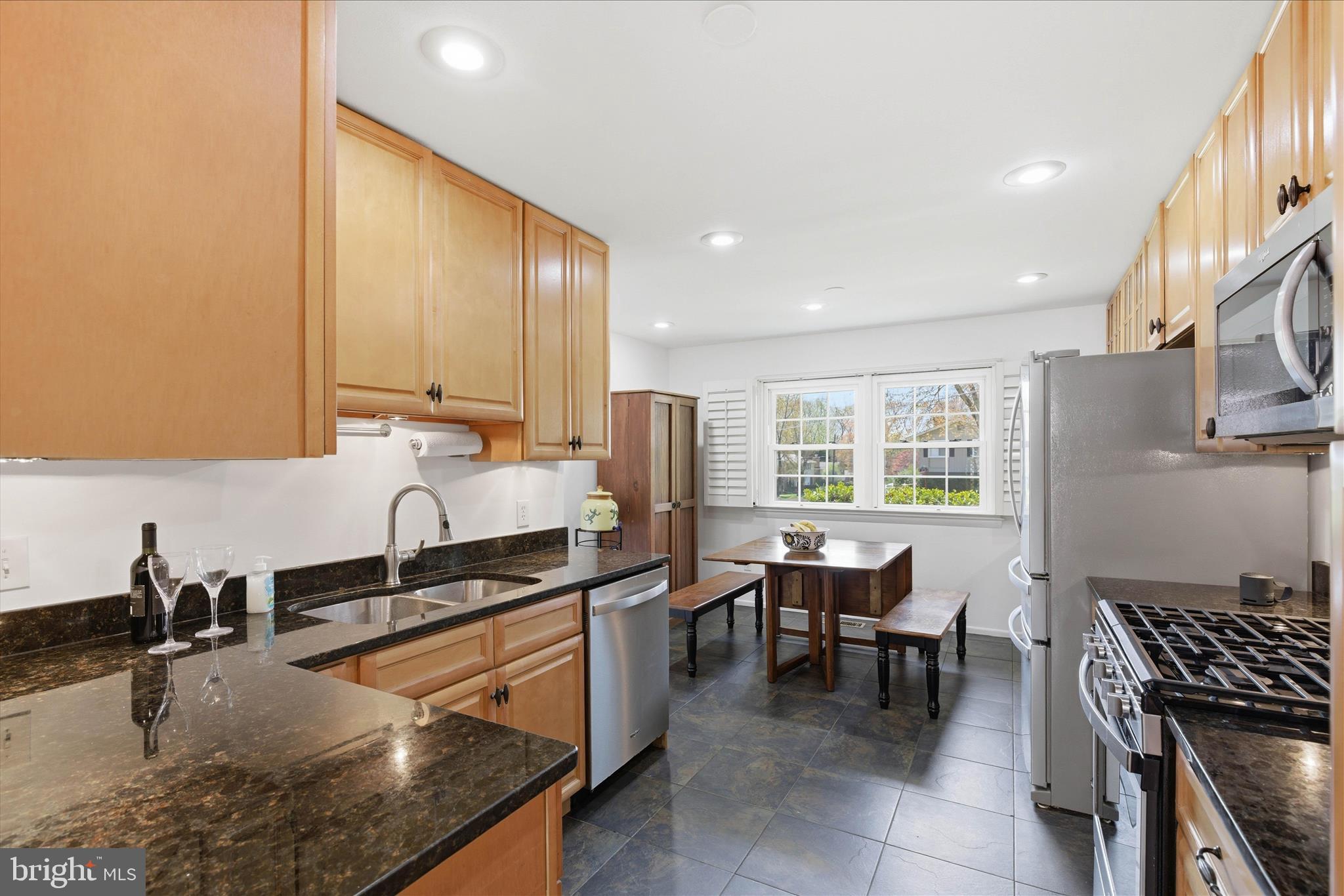 2510 Swift Run Street Vienna, VA 22180 - Photo 14 of 42 a kitchen with kitchen island granite countertop a sink a counter top space appliances and cabinets