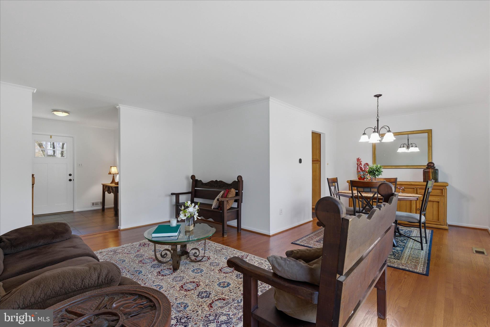 2510 Swift Run Street Vienna, VA 22180 - Photo 20 of 42 a living room with furniture and a chandelier