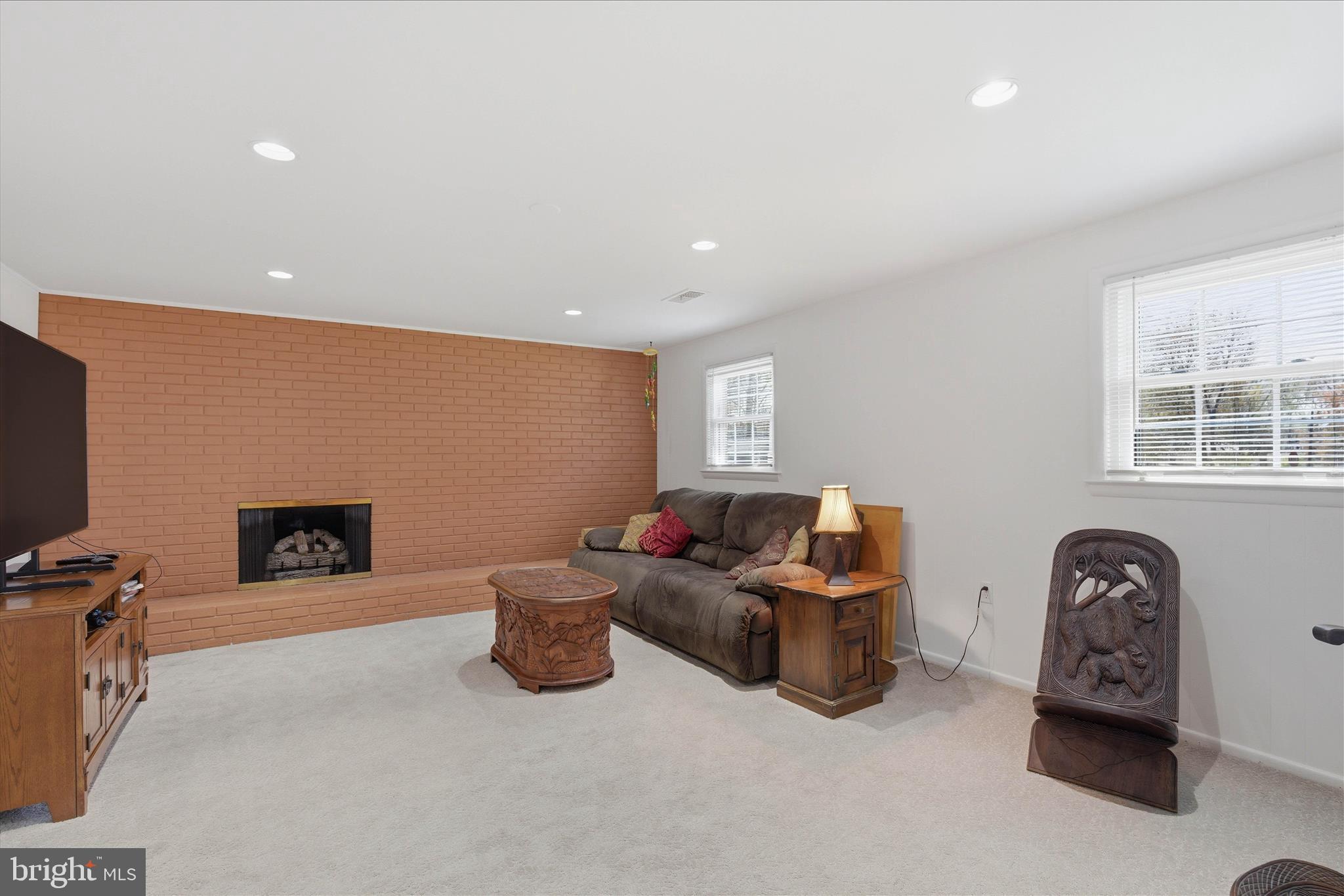 2510 Swift Run Street Vienna, VA 22180 - Photo 29 of 42 a living room with furniture and a fireplace