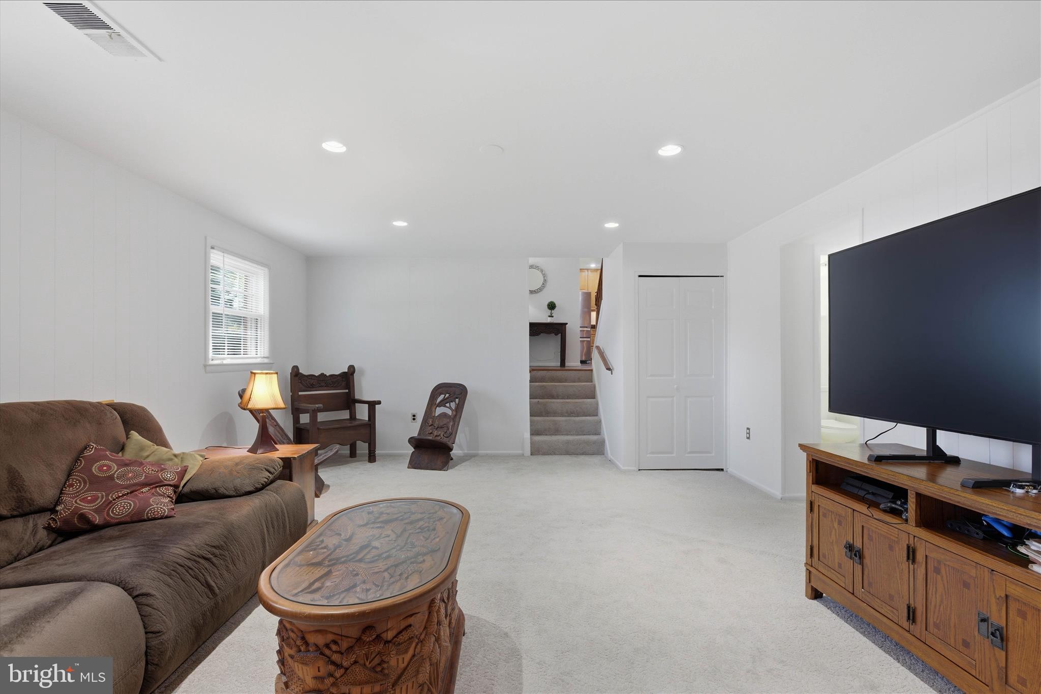 2510 Swift Run Street Vienna, VA 22180 - Photo 31 of 42 a living room with furniture and a flat screen tv