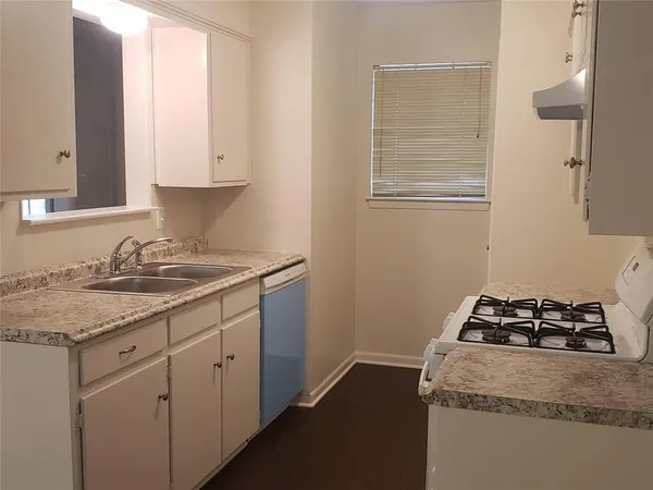 a kitchen with sink cabinets and stove