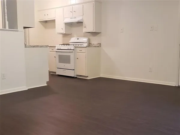 a kitchen with a stove and a refrigerator