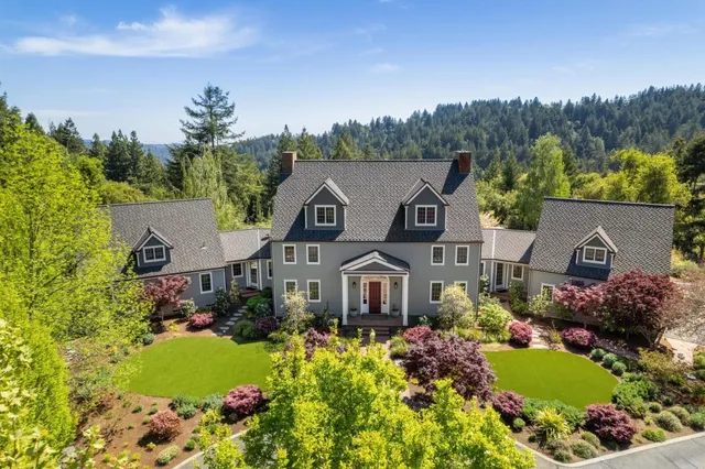 a front view of a house with a garden